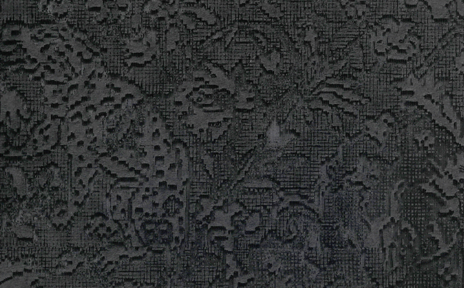 Texture detail of floral motif laser etched into black paper.
